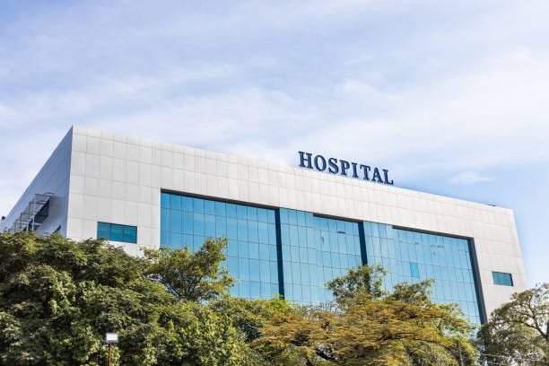 Modern building facade with Hospital word signage against blue sky