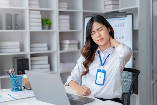 Asian businesswoman tired suffering from neck pain Back pain due to prolonged use of laptop computer at work.