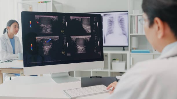 Adult Asian male doctors medical checking x-ray image of patient on computer screen in hospital. Medical health care concept.